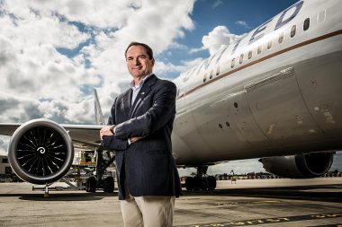 A man stood by an aeroplane for a corporate portrait at Heathrow airport in London