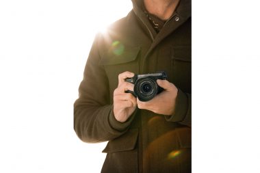 Advertising lifestyle photograph of a man holding a camera