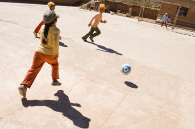 Advertising photograph of children playing football in Bolivia