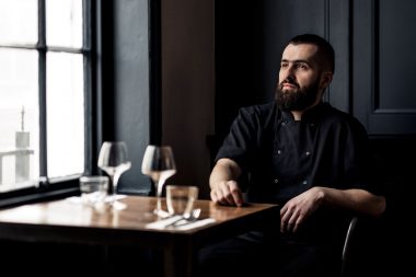 A chef sitting at a table at Plateau Reastaurant in Brighton