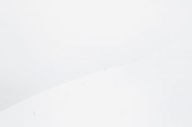 Blue posts disappearing over a snow covered slope in Norway