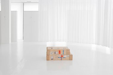Boxes of artwork in a white gallery in Cape Town.