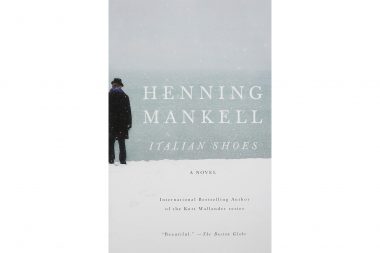 A man on a beach on the cover of the Henning Mankell novel Italian Shoes