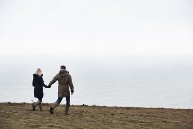 Couple walking near sea photographed for car advertising campaign