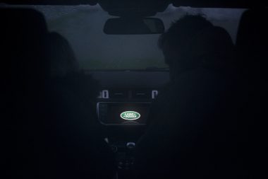 Night photograph of Land Rover logo inside Range Rover