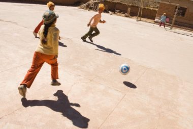 An advertising campaign image of children playing football