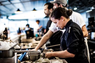 Photograph of chef preparing food at London restaurant event WastEd