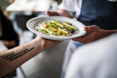 Photograph of food being served at London food event WastEd at Selfridges