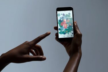 Photograph of hands holding a smart phone in a London photography studio