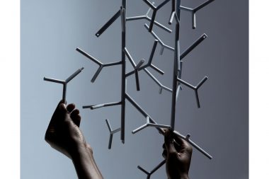 Photograph of hands holding plastic parts in a London studio