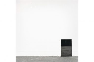 A black mirror leaning against a white studio wall in Edinburgh College of Art.