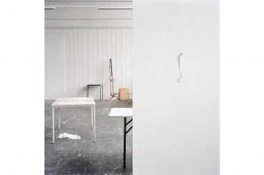 Tape on a studio wall, desks and a painting easel in an art studio by Richard Boll.