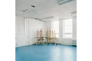 A group of painting easels in the corner of an art studio.