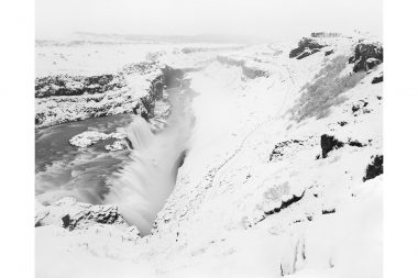 Waterfall and figures in snow covered landscape in Iceland by Richard Boll