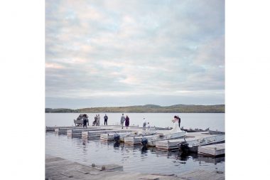 A wedding ceremony taking place on a pontoon on Gunflint Lake, Minnesota.