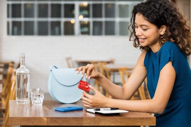 Lifestyle photograph of a woman in cafe with charging device