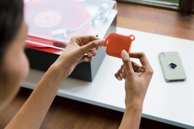 Photograph of woman holding smartphone accessory