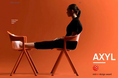 A woman sat on orange chairs in a studio