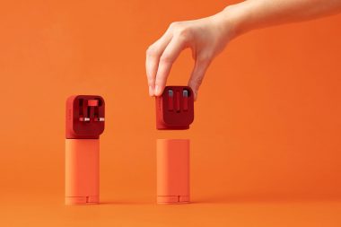 hand-with-nolii-charging-products-on-orange-background