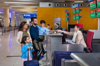 Family checking in at Dubai airport with Emirates airline