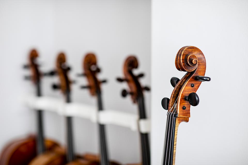 Product photography of cellos and violins in London