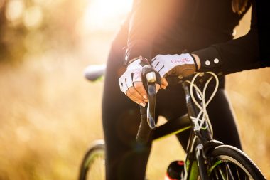 Lifestyle photograph of woman with cycling gloves