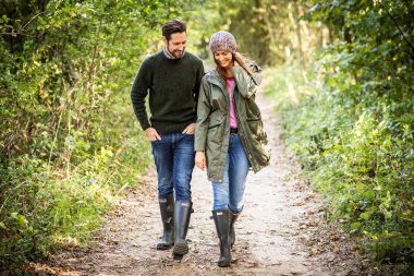 Commercial advertising photograph of couple walking in forest