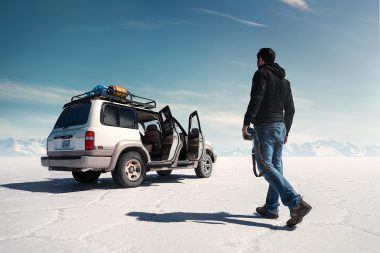 Photographer walking towards four wheeled drive vehicle in Bolivia for Sony global advertising campaign