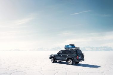 Four wheeled drive vehicle on Salar de uyun salt flats in Bolivia