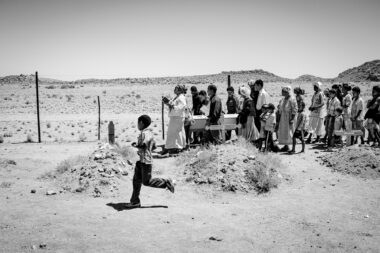 Mourners carrying a coffin at a funeral in Namibia by Richard Boll