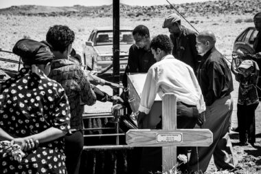 People carrying a coffin