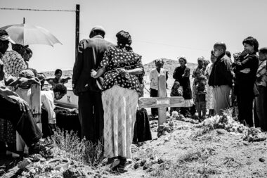 A black and white photograph of a funeral