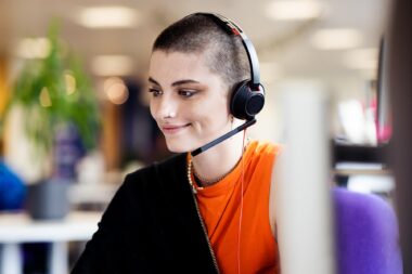 Woman with headphones working in a corporate environment