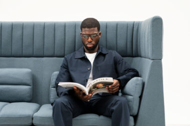 Oran soft seating with a model reading a magazine photographed for Allermuir