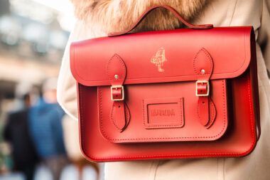 Red satchel on a woman's back in Covent Garden, London