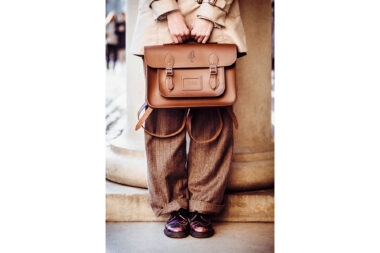 Woman holding a brown satchel in Covent Garden, London by Richard Boll
