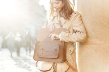 Woman taking a diary out of a Cambridge Satchel Co satchel