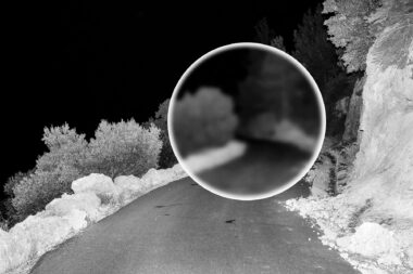 A road at night in Crete with a circle of blurred image.