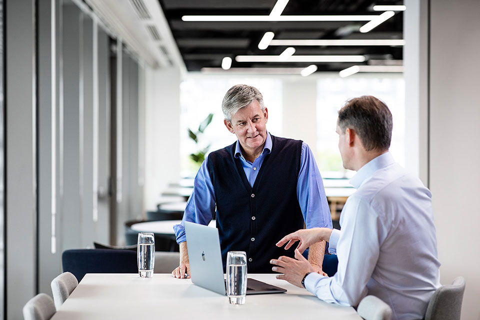 Office workers discussing ideas in a corporate environment. Richard Boll Photography, London