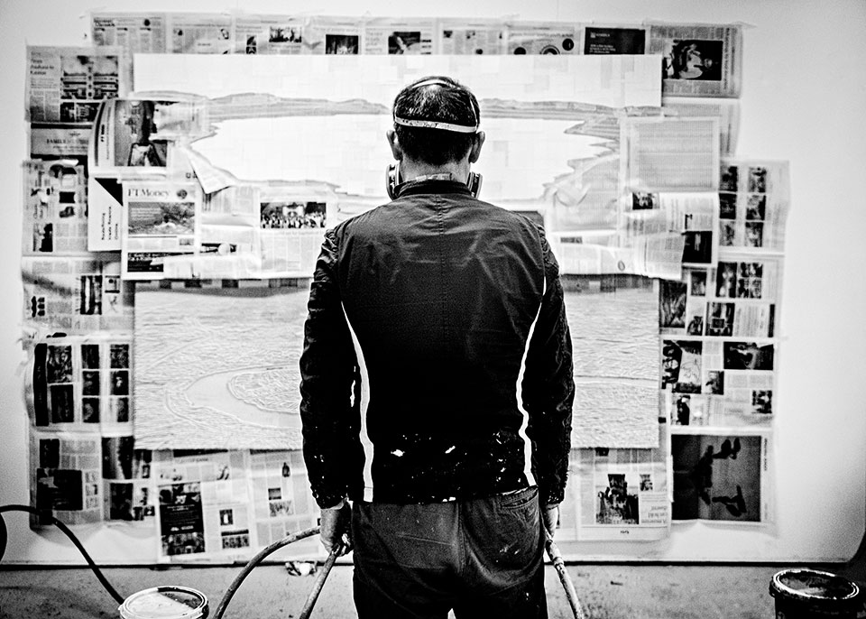 The London-based artist Gordon Cheung facing toward a picture that he's about to start painting.