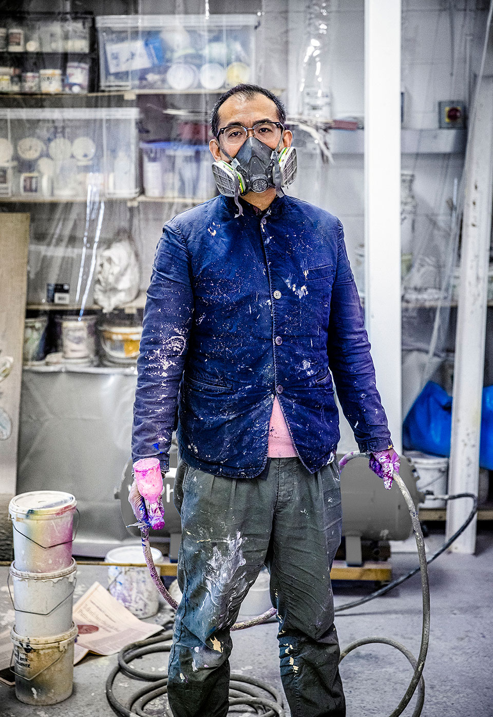 The artist Gordon Cheung wearing a mask ready to spray paint a new picture. Portrait photo by Richard Boll of London.