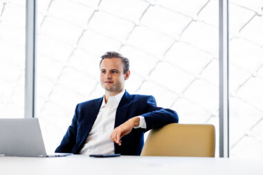 A man sitting down in a corporate boardroom.