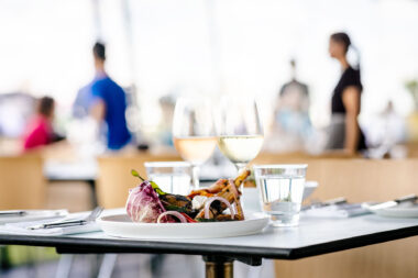 A plate of food with glasses of wine for marketing photography at The OXO Tower Bar