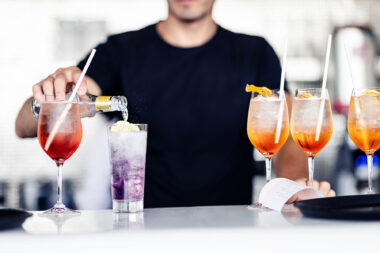 A man pouring a drink at The OXO Tower Restaurant Bar and Brasserie in London