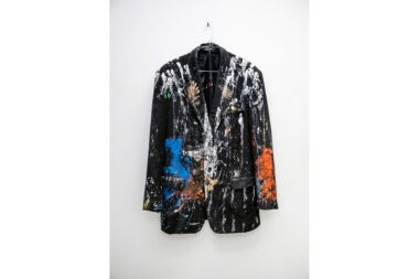 A paint splattered jacket hanging in the studio of Gavin Turk.