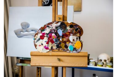 An palette on an easel in the studio of Gavin Turk.