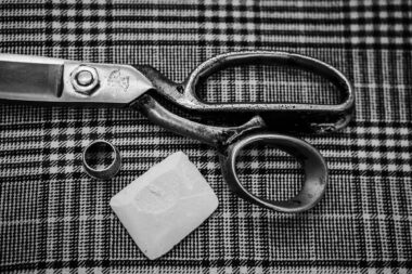 Scissors and tailor's chalk on tartan material on Savile Row in London.