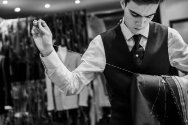 A tailor sewing a bespoke jacket on Savile Row in London.