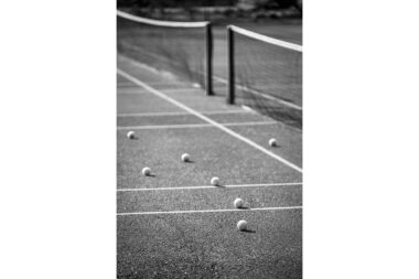 Tennis balls on an empty tennis court in London.