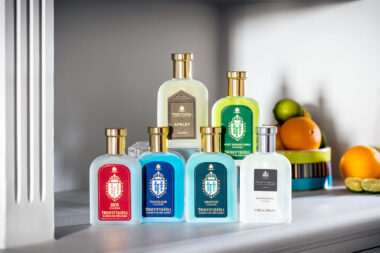 A photograph of a series of colognes by Truefitt and Hill on a shelf with some fruit.